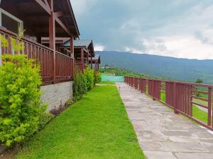 a balcony of a house with a swimming pool at IBP Estate in Rānīkhet