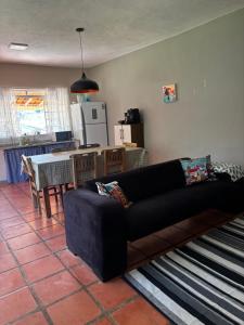 a living room with a couch and a kitchen at Villa Dona Jaca - Casa da Mata - 01 in Socorro +24 photos