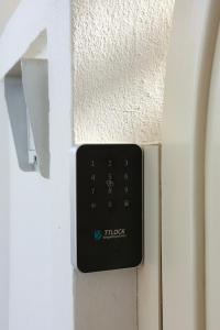 a remote control on the side of a wall at Villa Kyma in Platána +22 photos