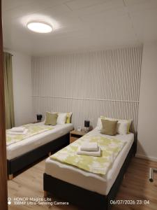 two beds in a small room with at Ferienwohnung Am Wald in Bad Marienberg