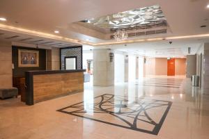 a lobby of a building with a sculpture on the floor at MGM Service Apartment by Savills Oman in Muscat +33 photos