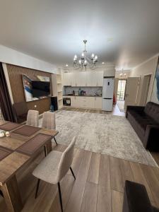 a living room with a couch and a table and chairs at Берег3 in Bosteri
