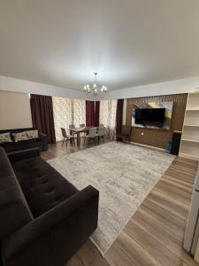 a living room with a couch and a table at Берег3 in Bosteri