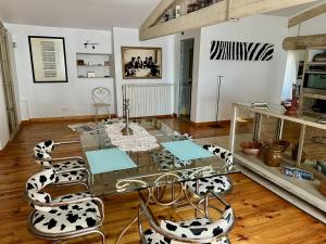 a living room with a glass table and chairs at Chez Christel in Apt