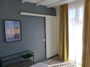 a bedroom with a bed and a large window at Hotel Castellamar in Sainte-Maxime