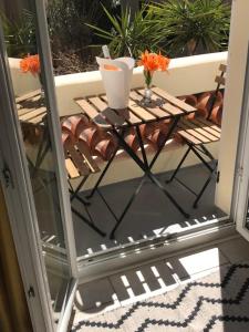 a small table on a balcony with a table at Hotel Castellamar in Sainte-Maxime