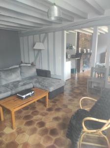 a living room with a couch and a coffee table at Les Rosiers in Onjon