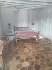 a bedroom with a bed and two night stands at Les Rosiers in Onjon