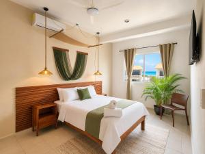 a bedroom with a large bed and a window at Hotel Isla Mujeres Centro & Beach Club Included in Isla Mujeres +139 photos