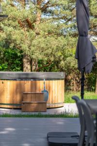 a wooden barrel sitting next to a wooden fence at LAS i MORZE in Czarny Młyn