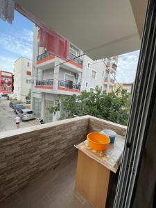 a balcony with an orange bowl on a table at Mateo Apartment in Himare +5 photos
