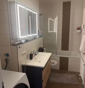a bathroom with a sink and a tub and a toilet at Ori's apartment in Frankfurt +9 photos