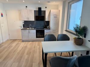 a kitchen with a table and chairs in a room at Idar Apartment 2 in Idar-Oberstein +6 photos