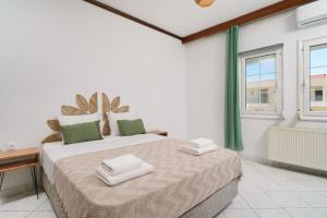 a bedroom with a large bed and a window at Solere Apartments in Limenaria