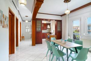 a kitchen and dining room with a table and chairs at Solere Apartments in Limenaria