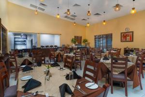 a dining room filled with tables and chairs at Amber Residence GRA Ikeja in Ikeja +24 photos