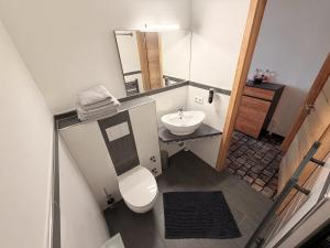 a small bathroom with a toilet and a sink at Sleep Inn Hotel in Paderborn +42 photos