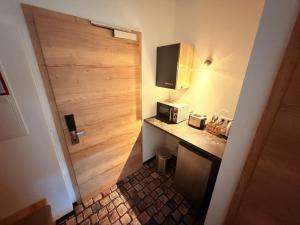 a small kitchen with a counter and a microwave at Sleep Inn Hotel in Paderborn