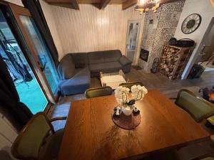 a living room with a wooden table and a couch at Rodzinne Zacisze in Radawa