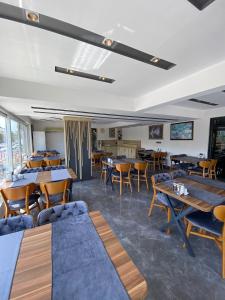 a restaurant with tables and chairs in a room at KENT HOTEL Didim in Didim