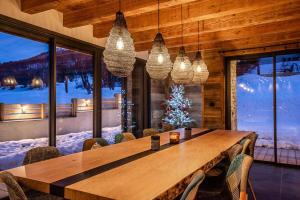 a dining room with a table and a christmas tree at Beleza in La Salle-les-Alpes +15 photos
