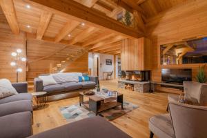 a living room with wooden walls and wooden floors at Aigle in Le Monêtier-les-Bains