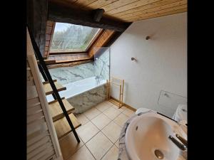 a bathroom with a ladder and a bath tub at Acolin in Briançon