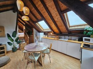 a kitchen with a table and chairs in a room at Acolin in Briançon +5 photos