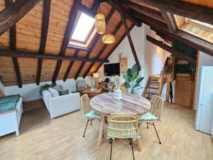 a kitchen and living room with a table and chairs at Acolin in Briançon