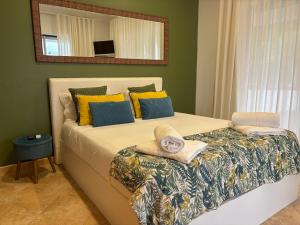 a bedroom with a large bed with a mirror on the wall at Chalé d'Angra Guest House in Angra do Heroísmo +45 photos
