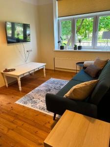 a living room with a couch and a coffee table at Baumanis klasika in Valmiera