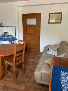 a living room with a table and a couch at Ubytování Adina in Velké Pavlovice