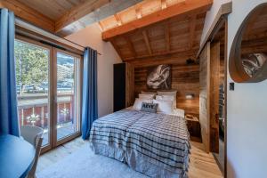 a bedroom with a bed and a large window at Galibier in Saint-Chaffrey +15 photos