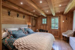 a bedroom with a large bed in a wooden room at Echyllo in Forville