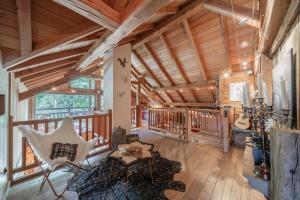 a large living room with wooden ceilings and rocking chairs at Echyllo in Forville
