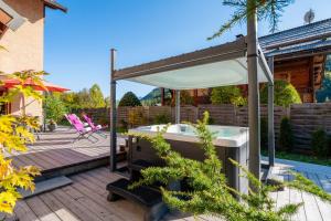 a hot tub on the deck of a house at Le Stam in La Salle-les-Alpes