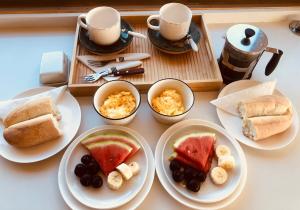 a table with plates of food and cups of coffee at Alojamiento y Desayuno Privado de Lujo C1 in Bucalemu