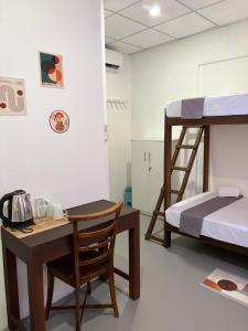 a room with a desk and a bunk bed at The Cottage Weligama in Weligama