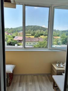 a room with three windows with a view at Appartement Landzeit im Waldviertel in Steinbach