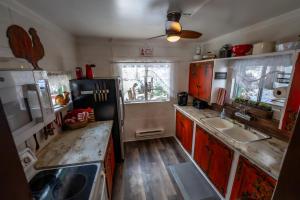 a kitchen with a black refrigerator and a sink at Cottage On The Stream Sundance, Utah in Sundance