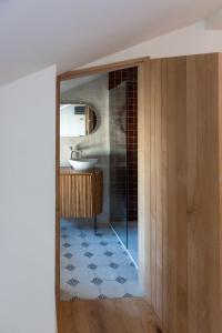 a bathroom with a tub and a sink at Hôtel Le Groom in Laprade +67 photos