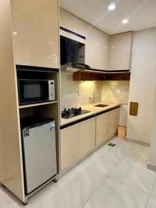 a kitchen with a refrigerator and a microwave at Premium Pavilion in Islamabad