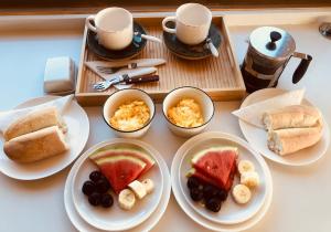 a table with plates of food and cups of coffee at Alojamiento y Desayuno Privado de Lujo C1 in Bucalemu +47 photos
