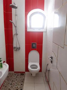 a small bathroom with a toilet and a window at ben mesaaoud in Kelibia