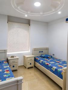 a bedroom with two beds and a window at ben mesaaoud in Kelibia