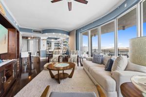 a living room with a couch and a table at The Alexander in Rosemary Beach