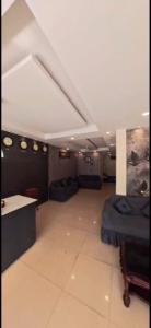 a large room with couches and a bed in it at HOTEL MEREDIAN GRAND INn in Shamshabad