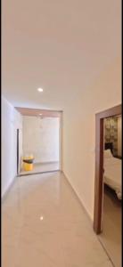 an empty room with a bed and a hallway at HOTEL MEREDIAN GRAND INn in Shamshabad