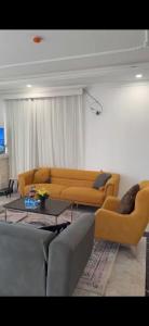 a living room with a couch and a table at Telimas tourism in Erbil