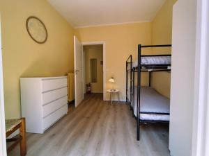 a room with two bunk beds and a dresser at casa marina in Pettenasco